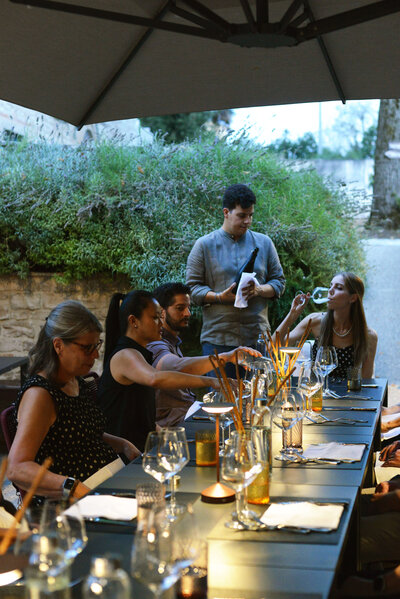 a small group of people on an off the beaten path of italy tour enjoying food and wine