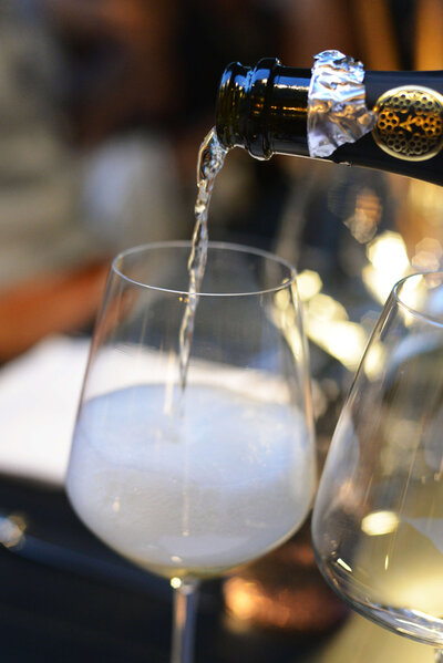 Wine being poured into a glass on On the Italian on Tour’s Celiac-friendly Gluten Free Italy Tour