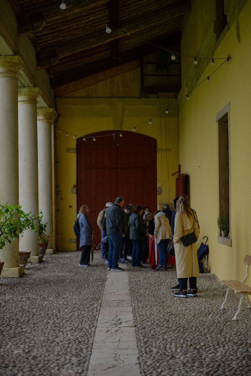 A small group of people touring a building On the Italian on Tour’s 10 day Northern Italian Delights Food & Wine Tour