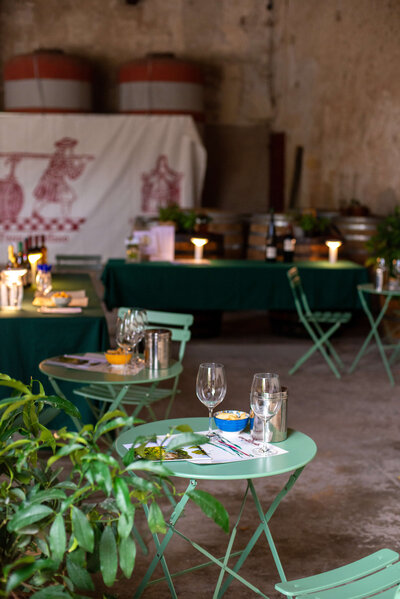 A beautifully arranged wine tasting table in a historic Italian venue, featuring glasses, bottles, and artisanal food on a small group tour.