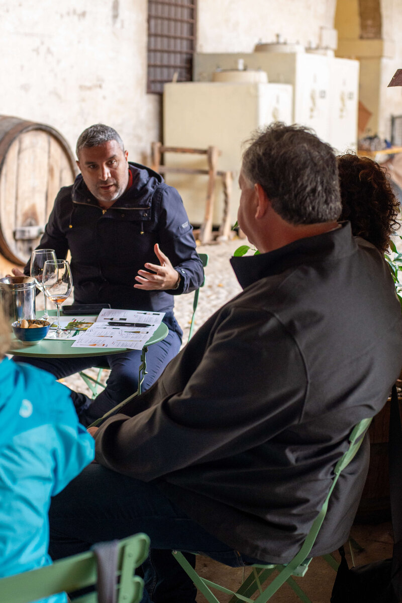 Two small tables chatting at a cafe outside On the Italian on Tour’s 10 day Northern Italian Delights Food & Wine Tour