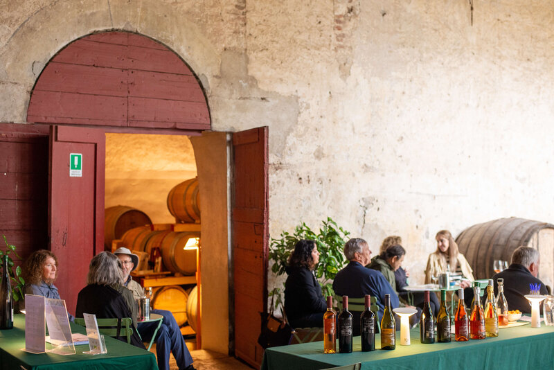 Three people dining outside a winery On the Italian on Tour’s 10 day Northern Italian Delights Food & Wine Tour