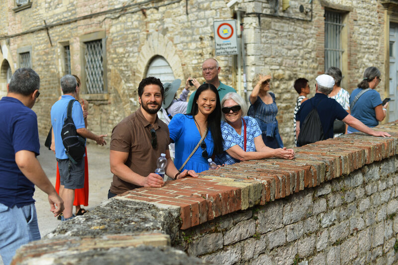 People smiling on a bridge On the Italian on Tour’s 10 day Italy Uncorked Small Group Tour