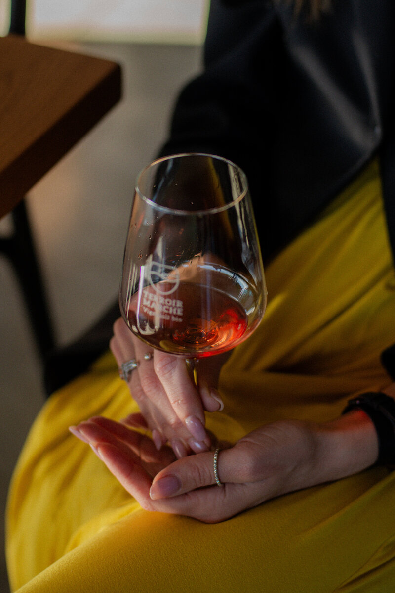 A woman holds a glass of wine On the Italian on Tour’s 10 day Epicurean Journey trip through Italy