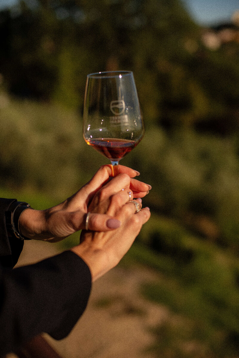 A person swirls a glass of red wine On the Italian on Tour’s 10 day Epicurean Journey trip through Italy