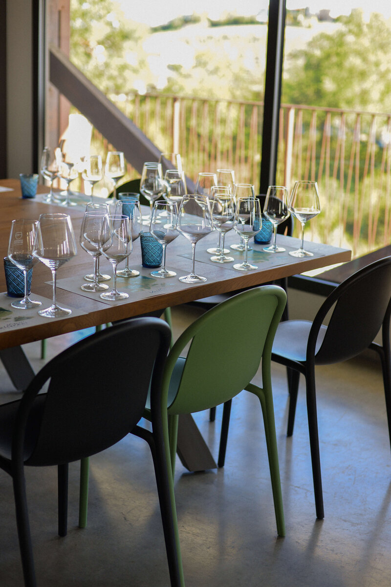 A beautifully set table with wine glasses and candles on an outdoor patio, ready for an intimate food and wine tour in Italy.