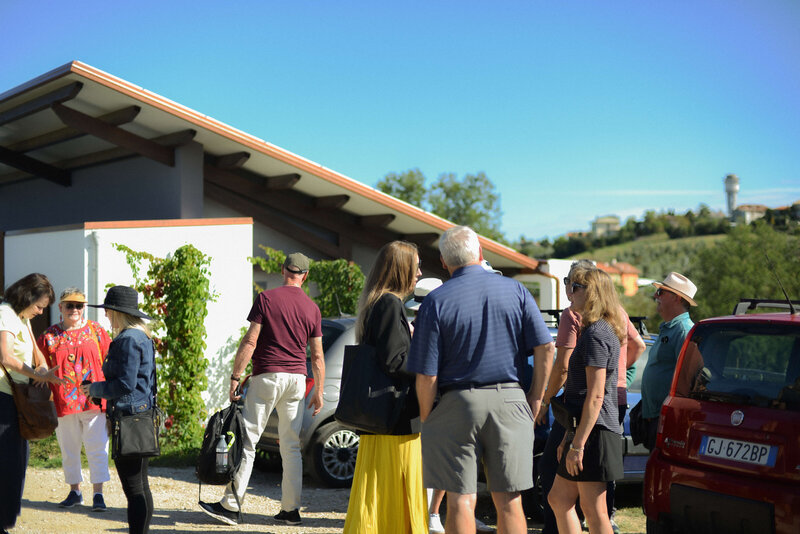 A group of people talking at a Cantina On the Italian on Tour’s 10 day Epicurean Journey trip through Italy