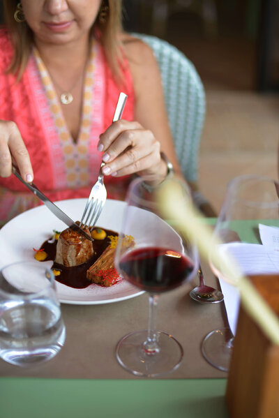 A person dining and drinking wine on a small group trip to Italy with the Italian on Tour
