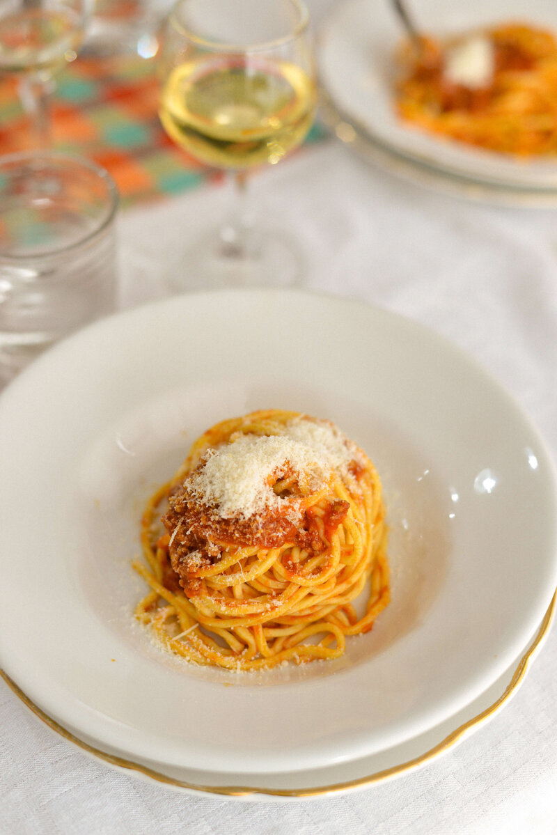 A plate of spaghetti topped with parmesean On the Italian on Tour’s 10 day Epicurean Journey trip through Italy