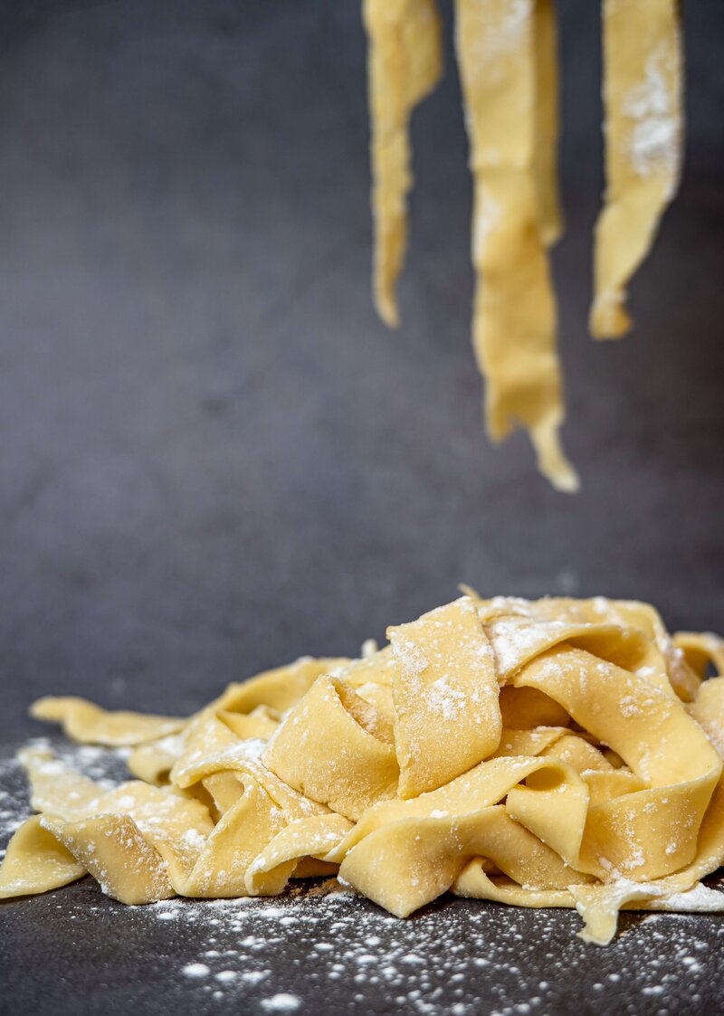 A plate of freshly made gluten-free pasta with wide ribbons, offering a delicious option for celiac-friendly dining in Italy.