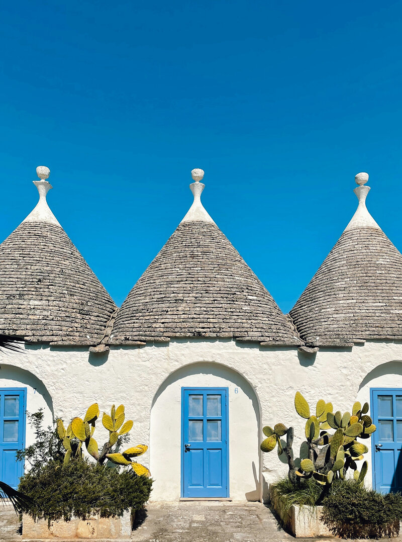 A picturesque brick house with a domed roof in Italy called Trulli homes which yu can visit in the Italian on Tour's Passport to Puglia 8-day small group trip to Italy