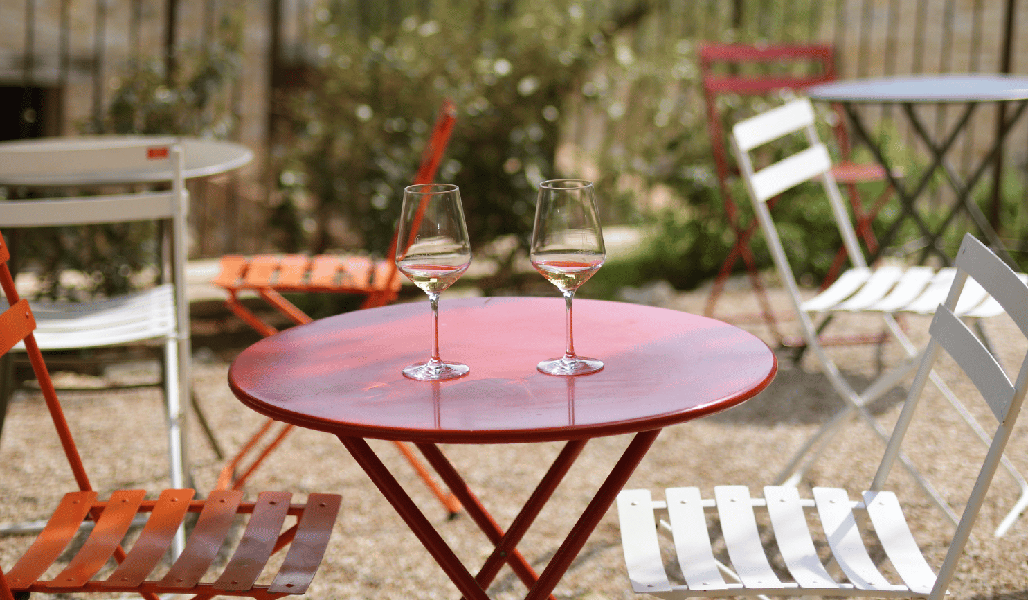 a red table with two wine glasses on a wine tours in umbria italy