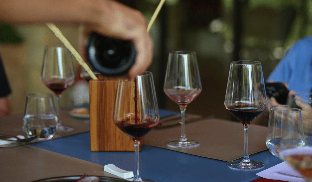 glasses of wine on a table being filled with red wine on a wine tour in umbria italy